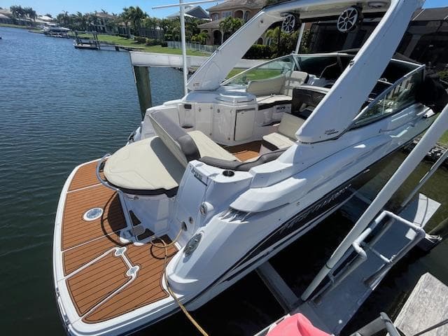 2019 Monterey 295 boat docked, featuring spacious deck and luxurious seating.