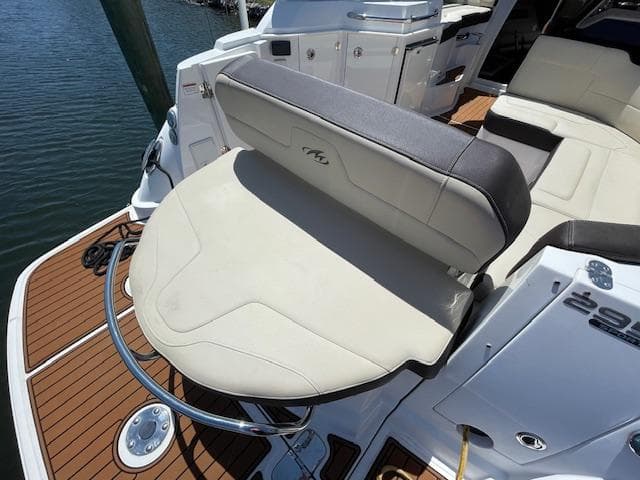 2019 Monterey 295 boat with cushioned seating and teak deck, docked by the water.