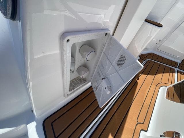 2019 Monterey 295 boat deck with open storage compartment and teak flooring.