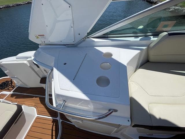 2019 Monterey 295 boat interior with seating and cup holders, docked by the water.