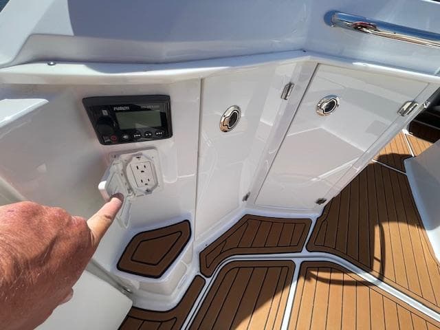 2019 Monterey 295 boat interior with control panel and wooden flooring.