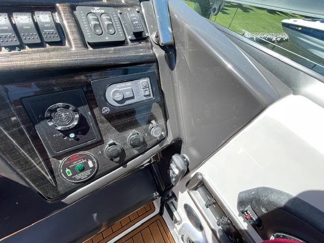 Control panel of a 2019 Monterey 295 boat with various switches and dials.