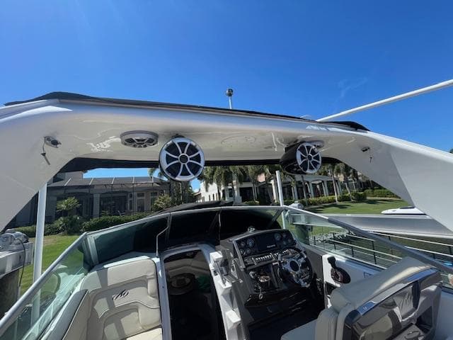 2019 Monterey 295 boat interior with speakers and control panel under clear blue sky.