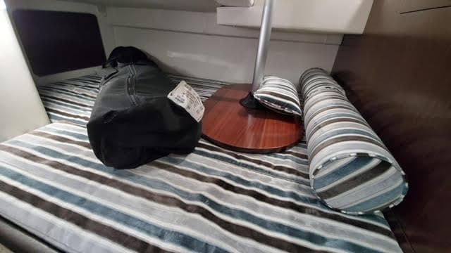 Interior cabin of 2019 Monterey 295 boat with striped bedding and accessories.