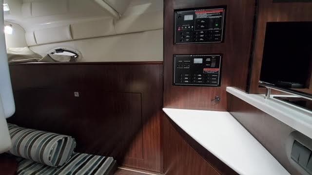 2019 Monterey 295 cabin interior with control panels and striped seating.