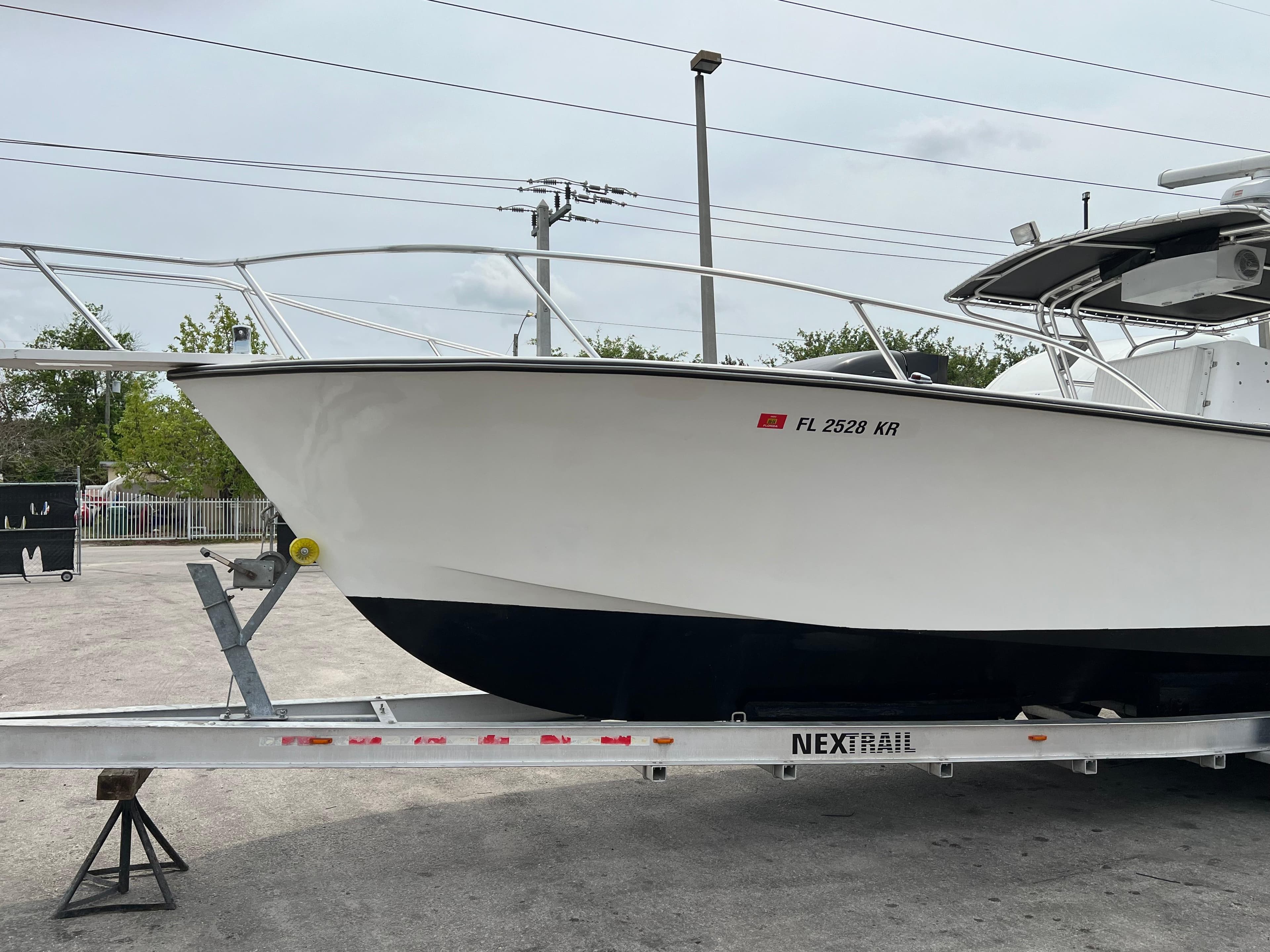 2000 Stuart Angler 32 Center Console boat on trailer, side view.