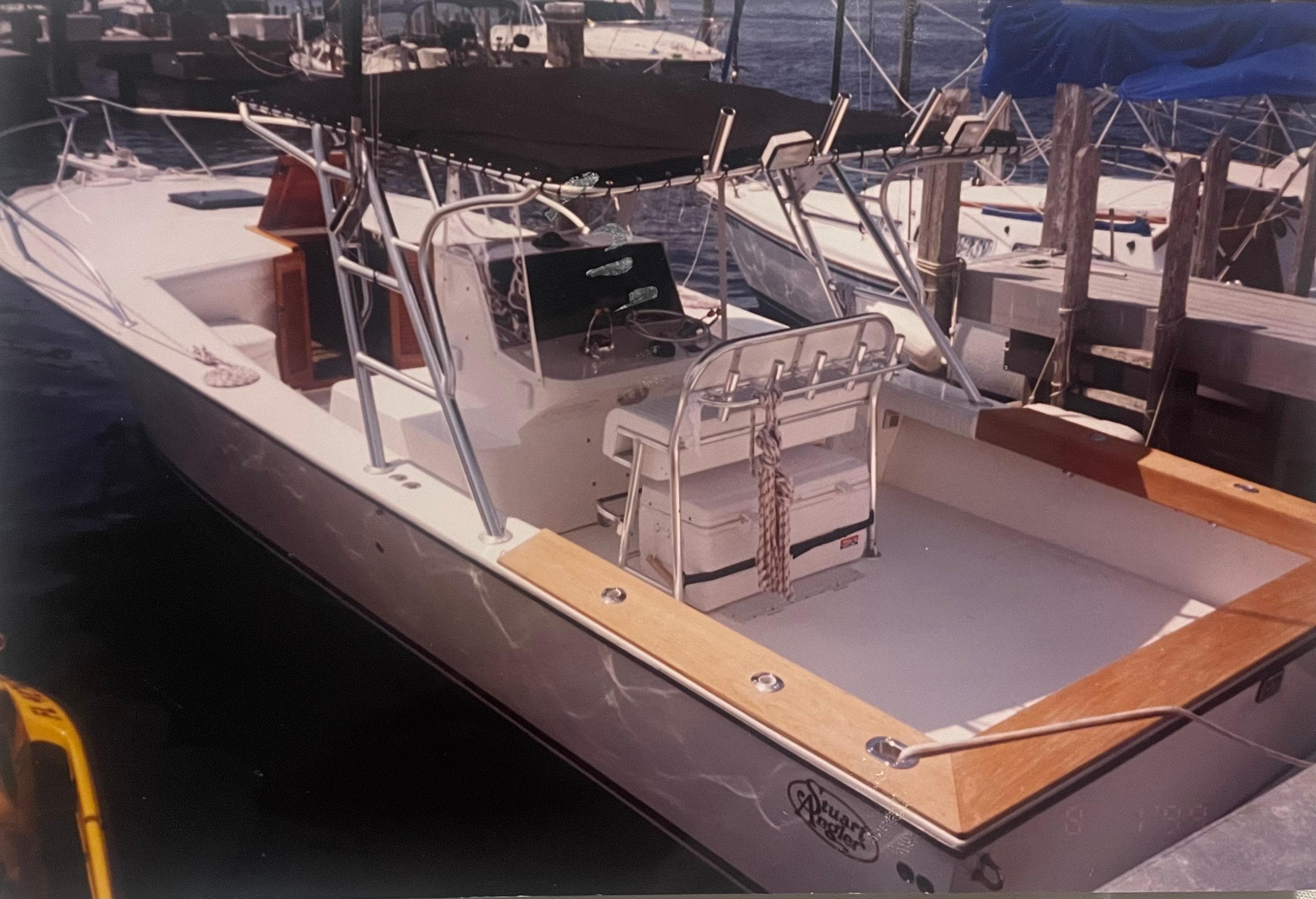 2000 Stuart Angler 32 Center Console/Cutty boat docked at marina.