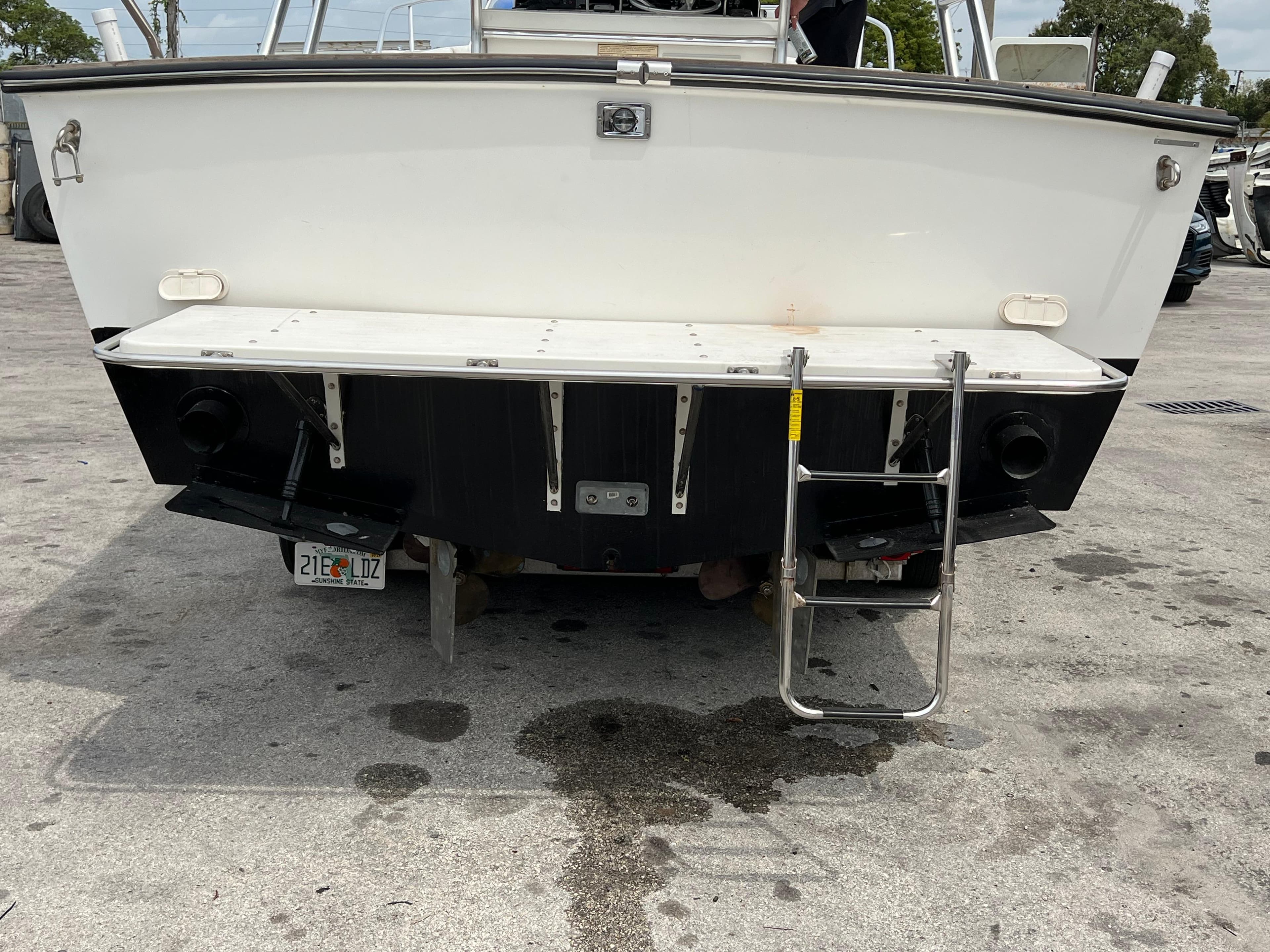 2000 Stuart Angler 32 Center Console boat rear view with ladder and license plate.