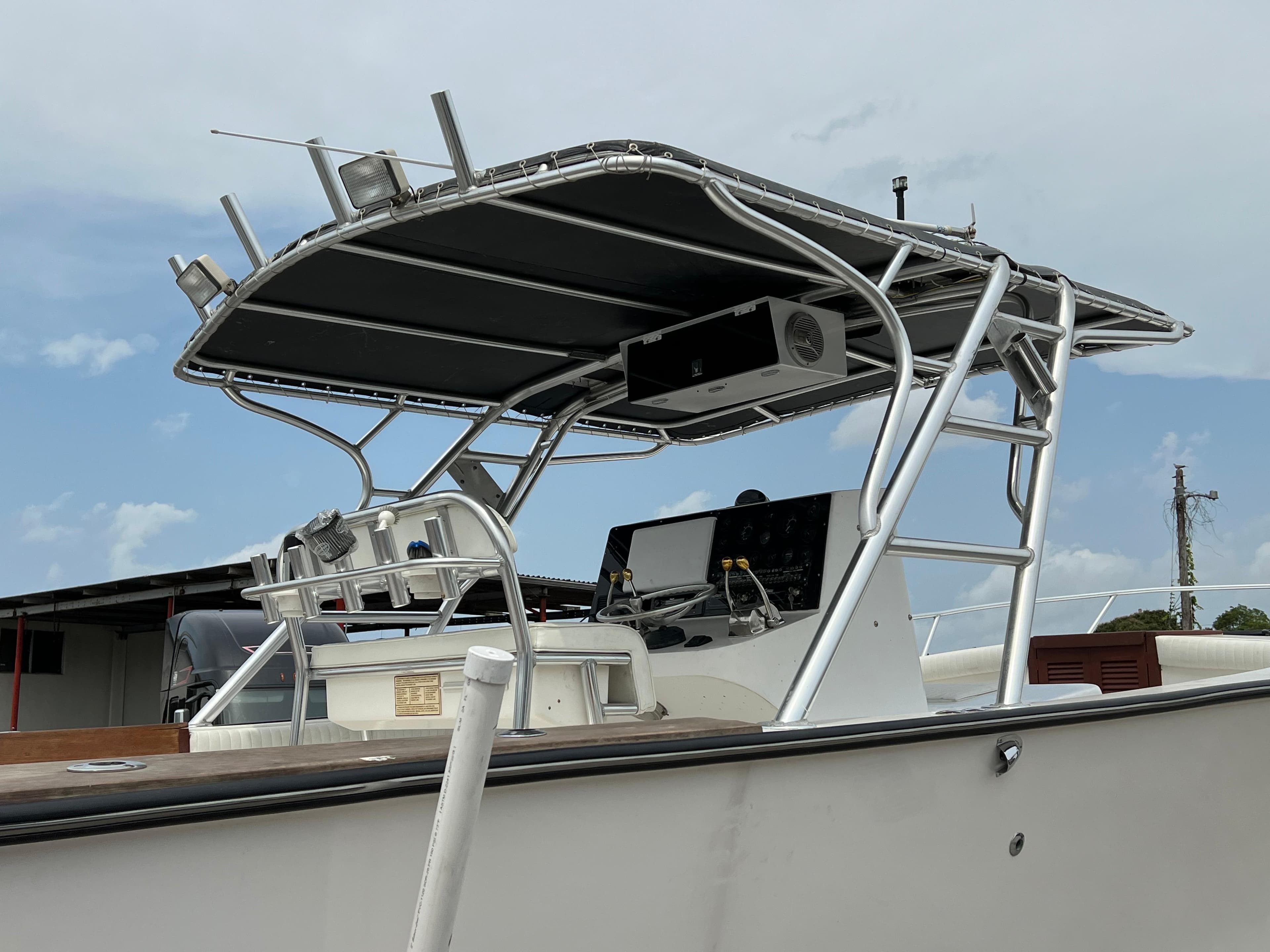 2000 Stuart Angler 32 Center Console boat with T-top and navigation equipment.