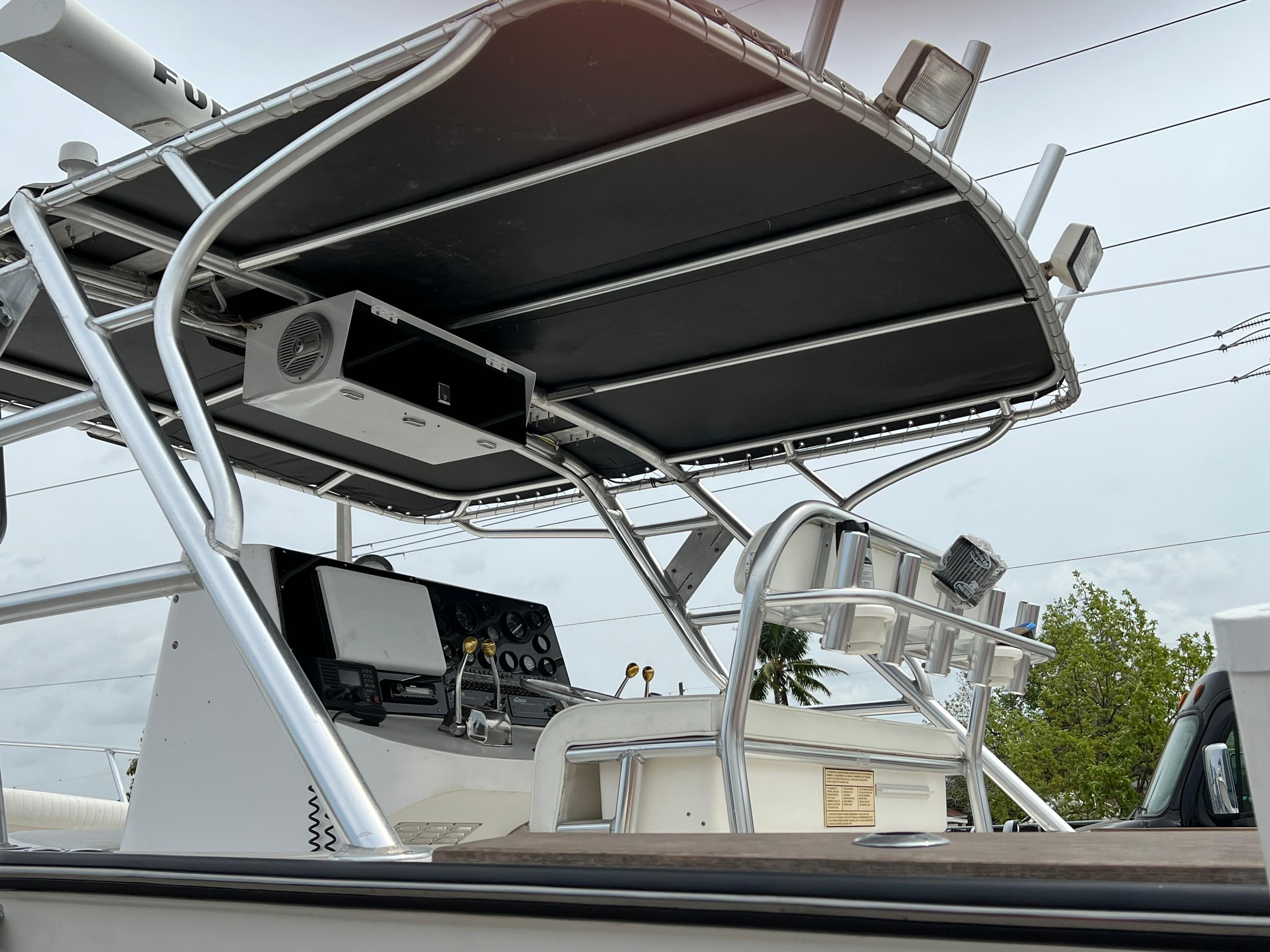 2000 Stuart Angler 32 Center Console boat with T-top and control panel.