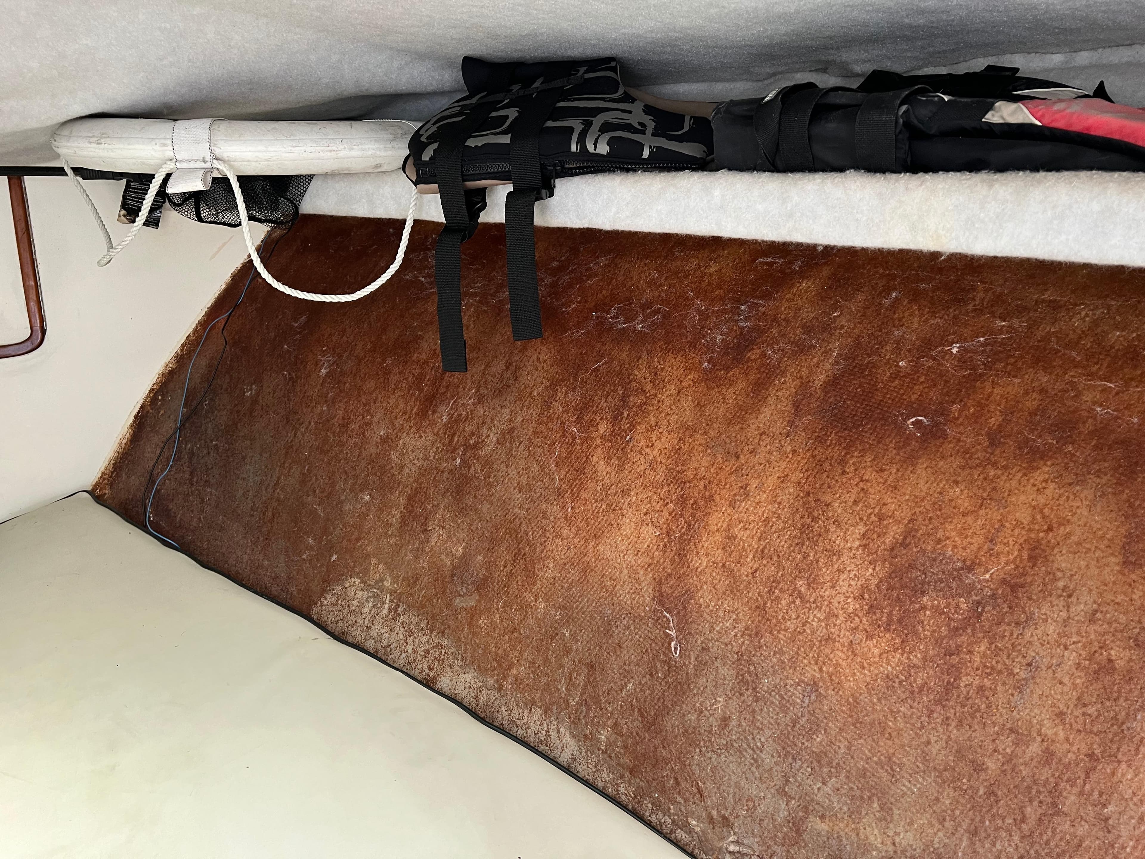 Interior of a 2000 Stuart Angler 32 Center Console/Cutty with life jackets and storage.