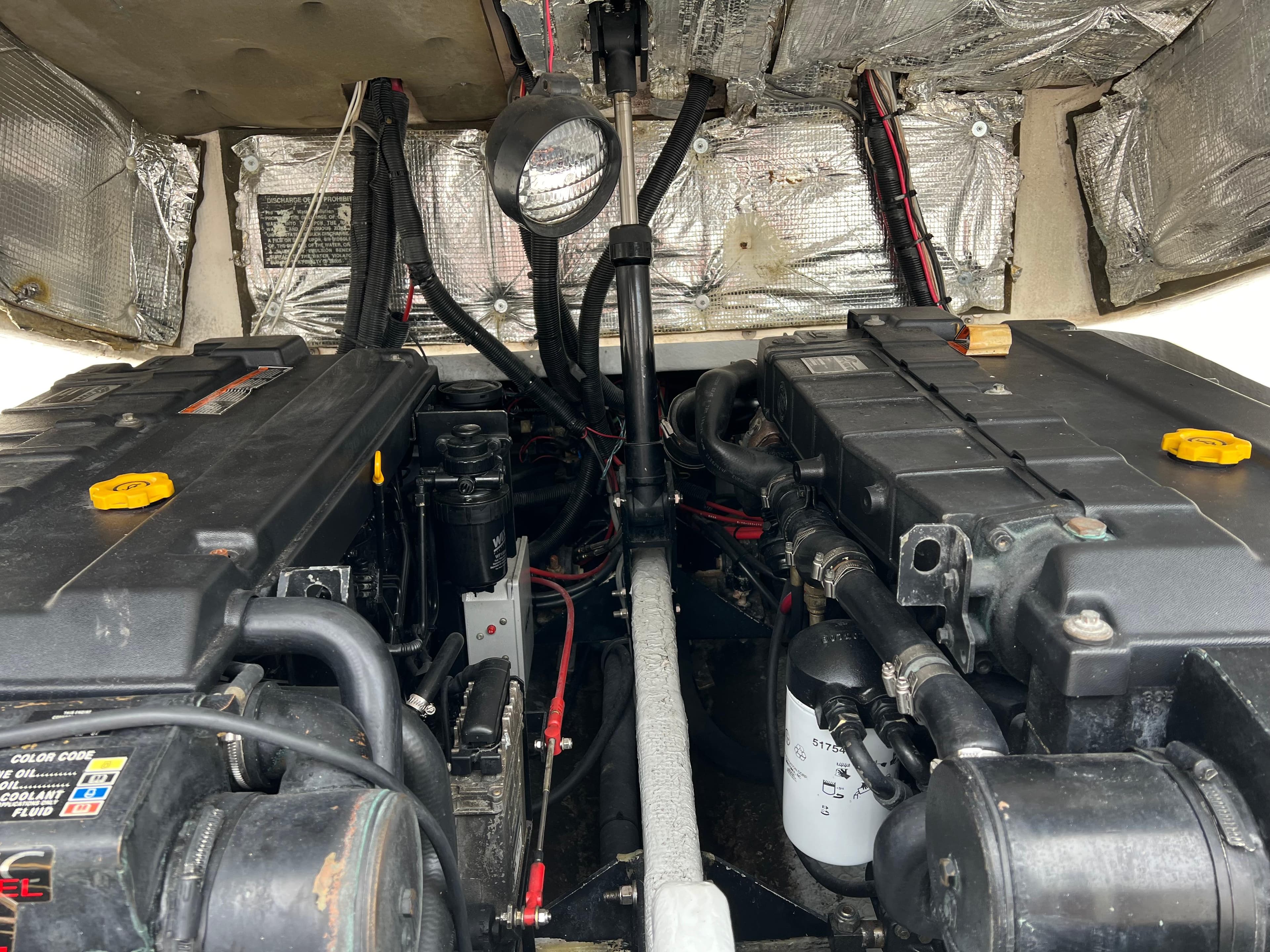 Engine compartment of a 2000 Stuart Angler 32 Center Console/Cutty boat, showing detailed machinery.