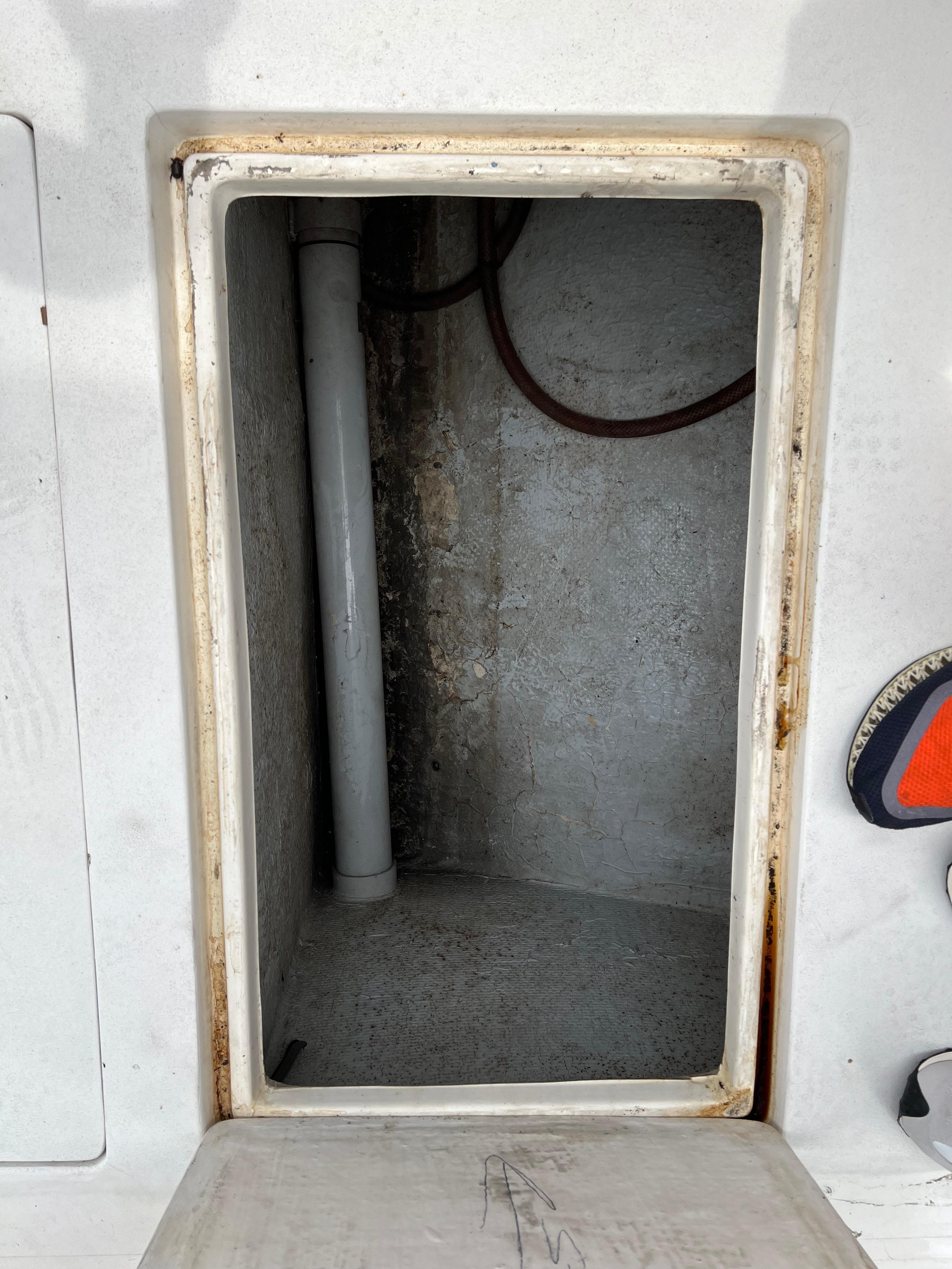 Open storage compartment on a 2000 Stuart Angler 32 Center Console boat.