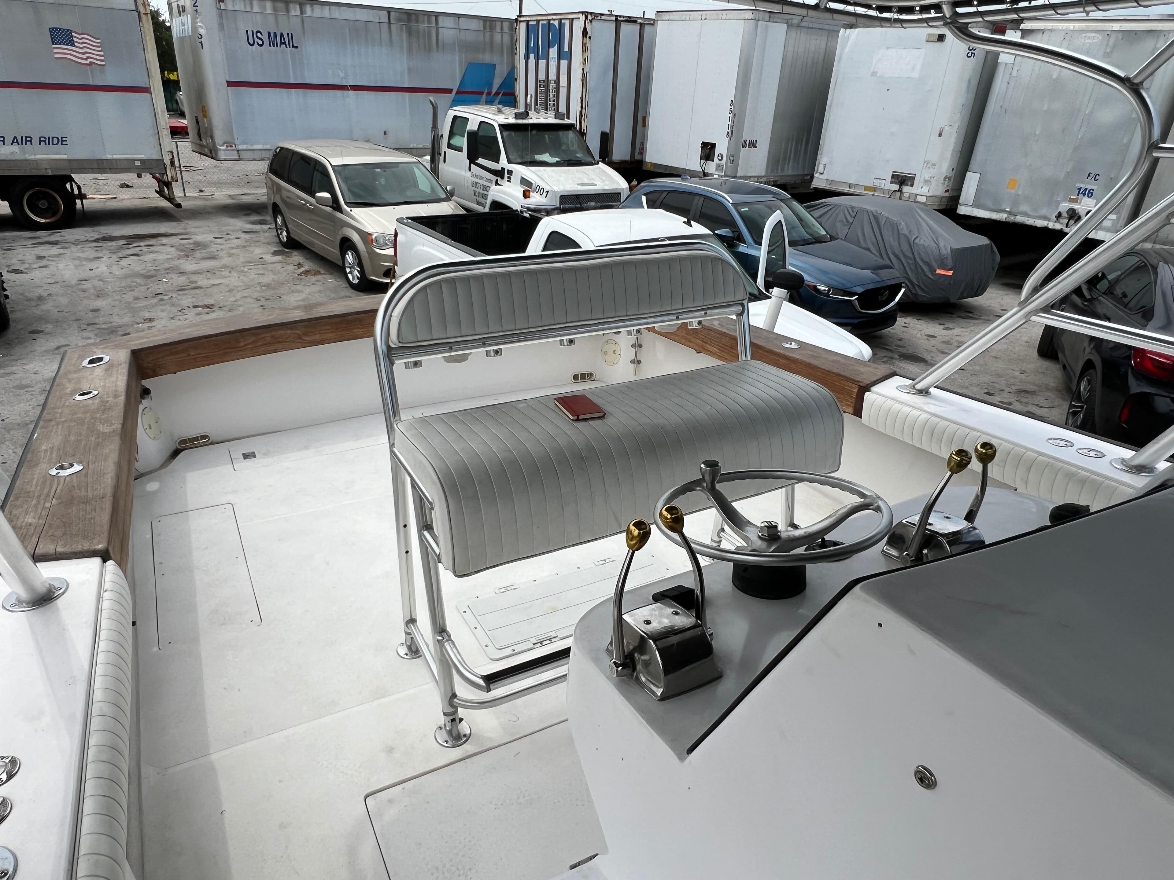 2000 Stuart Angler 32 Center Console boat interior with steering wheel and seating.