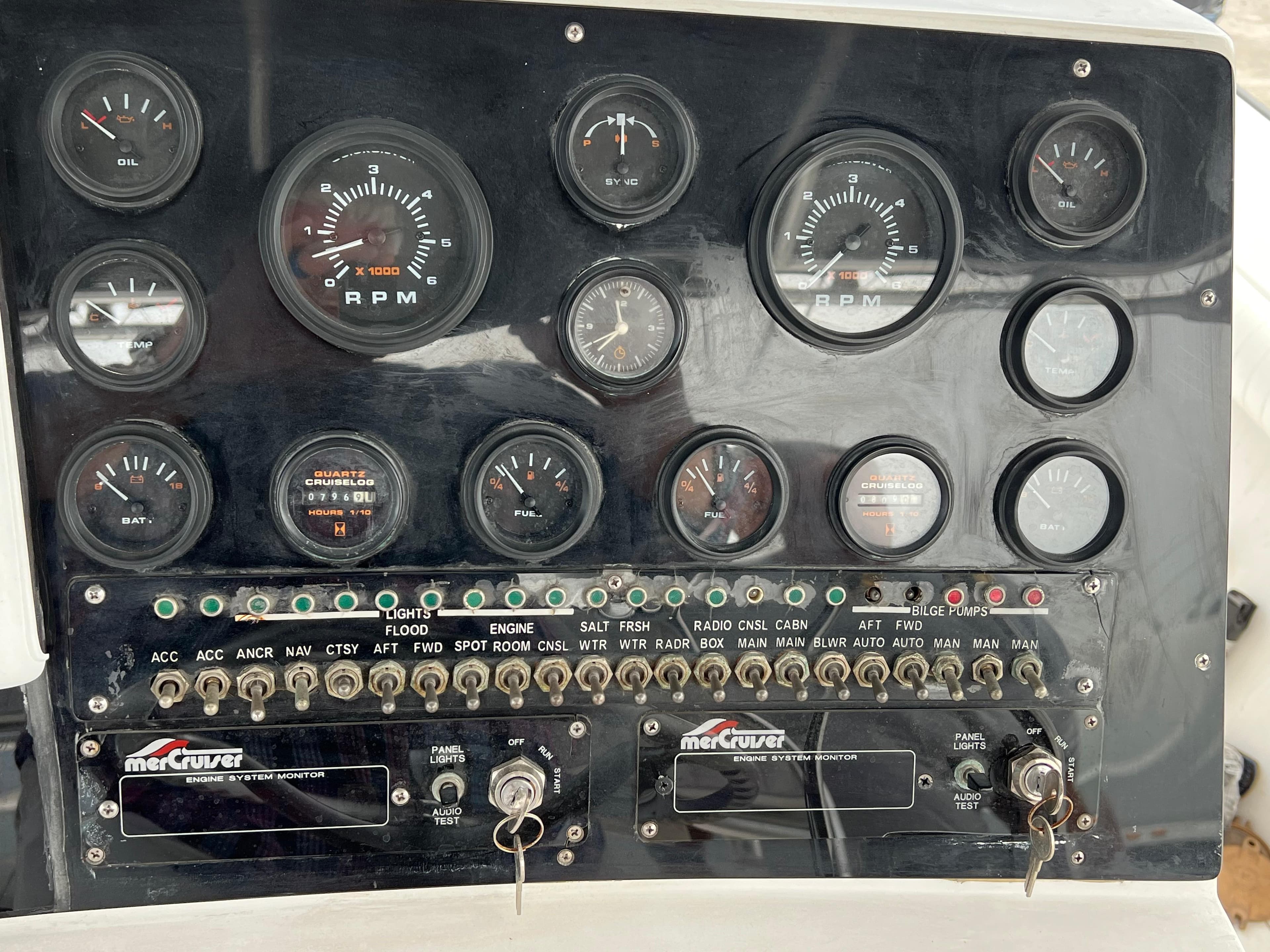 Instrument panel of a 2000 Stuart Angler 32 Center Console/Cutty boat with gauges and switches.