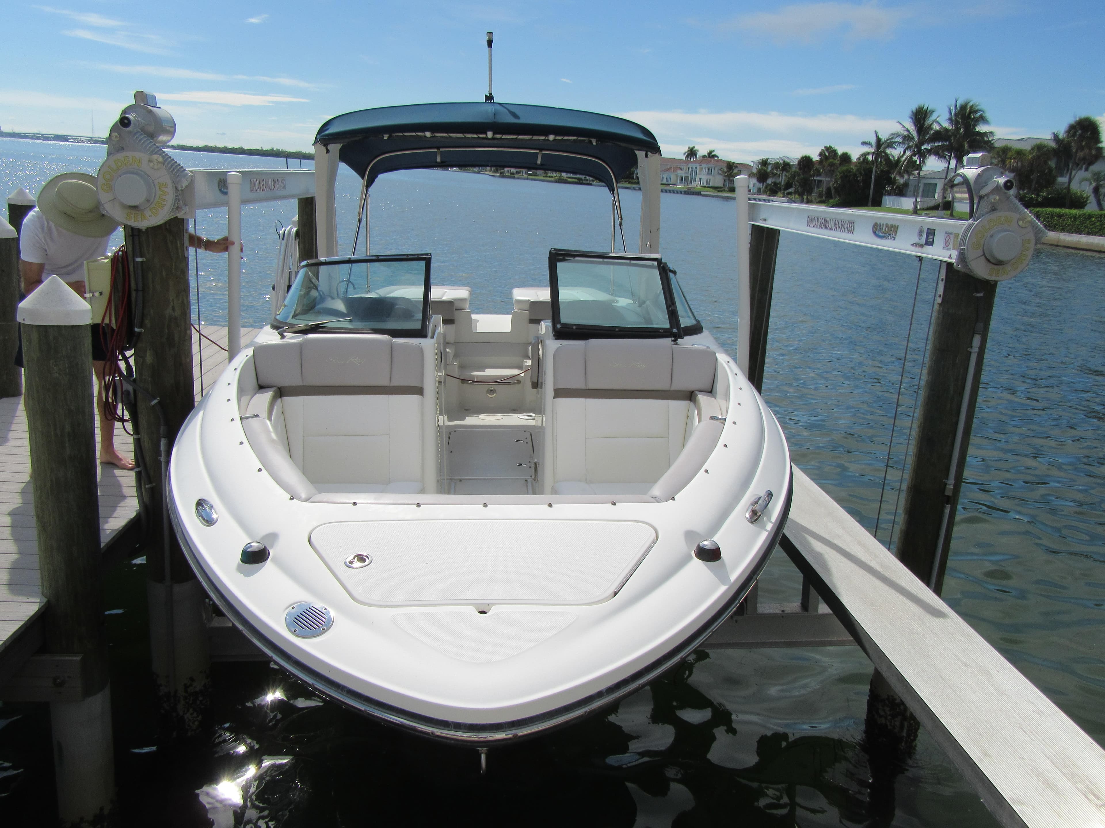 2011 Sea Ray 250 SLX boat docked on a sunny day by the water.