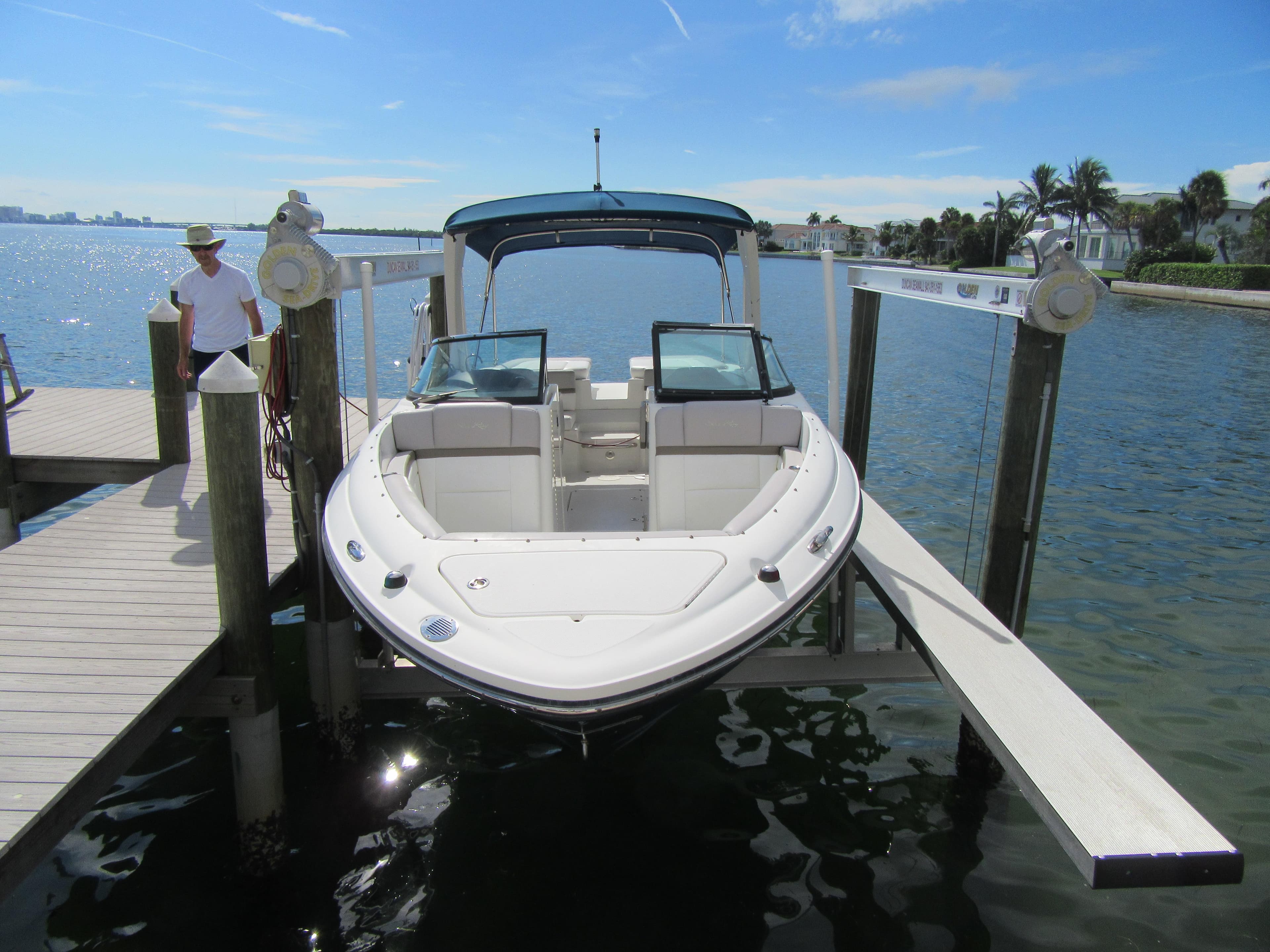 2011 Sea Ray 250 SLX boat docked on a sunny day.