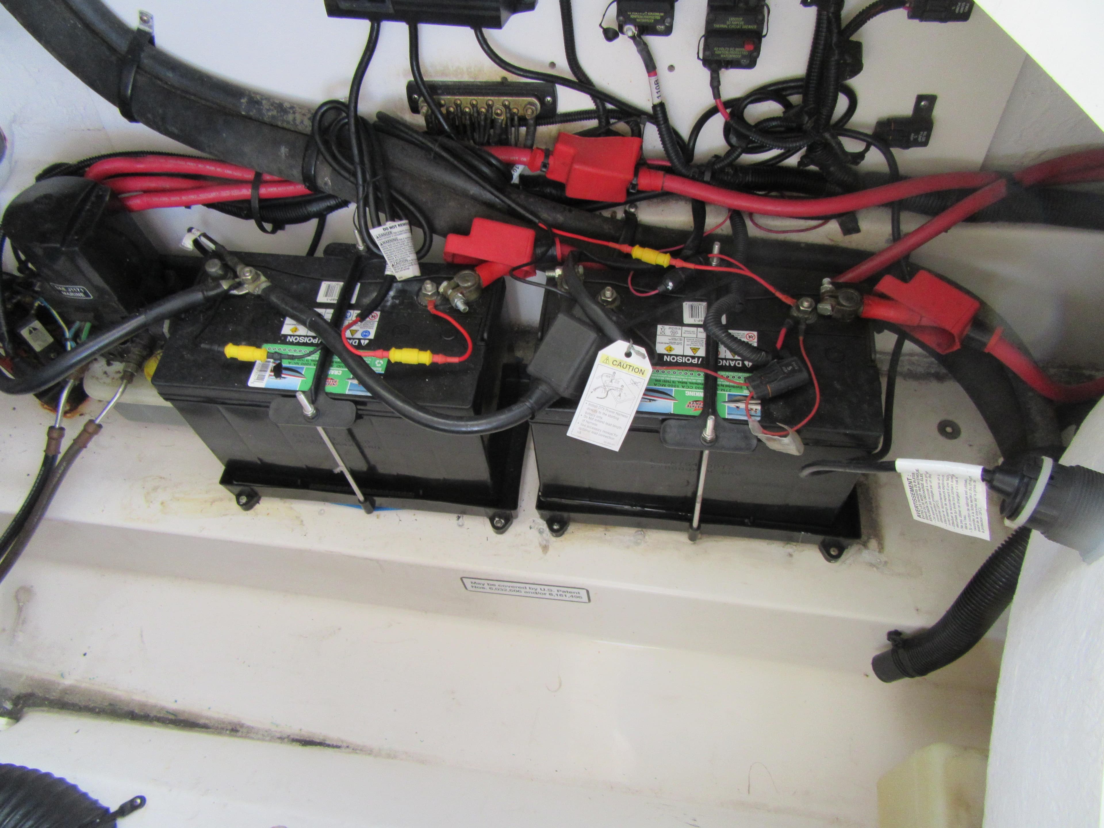 Battery compartment of a 2011 Sea Ray 250 SLX boat with wiring connections.