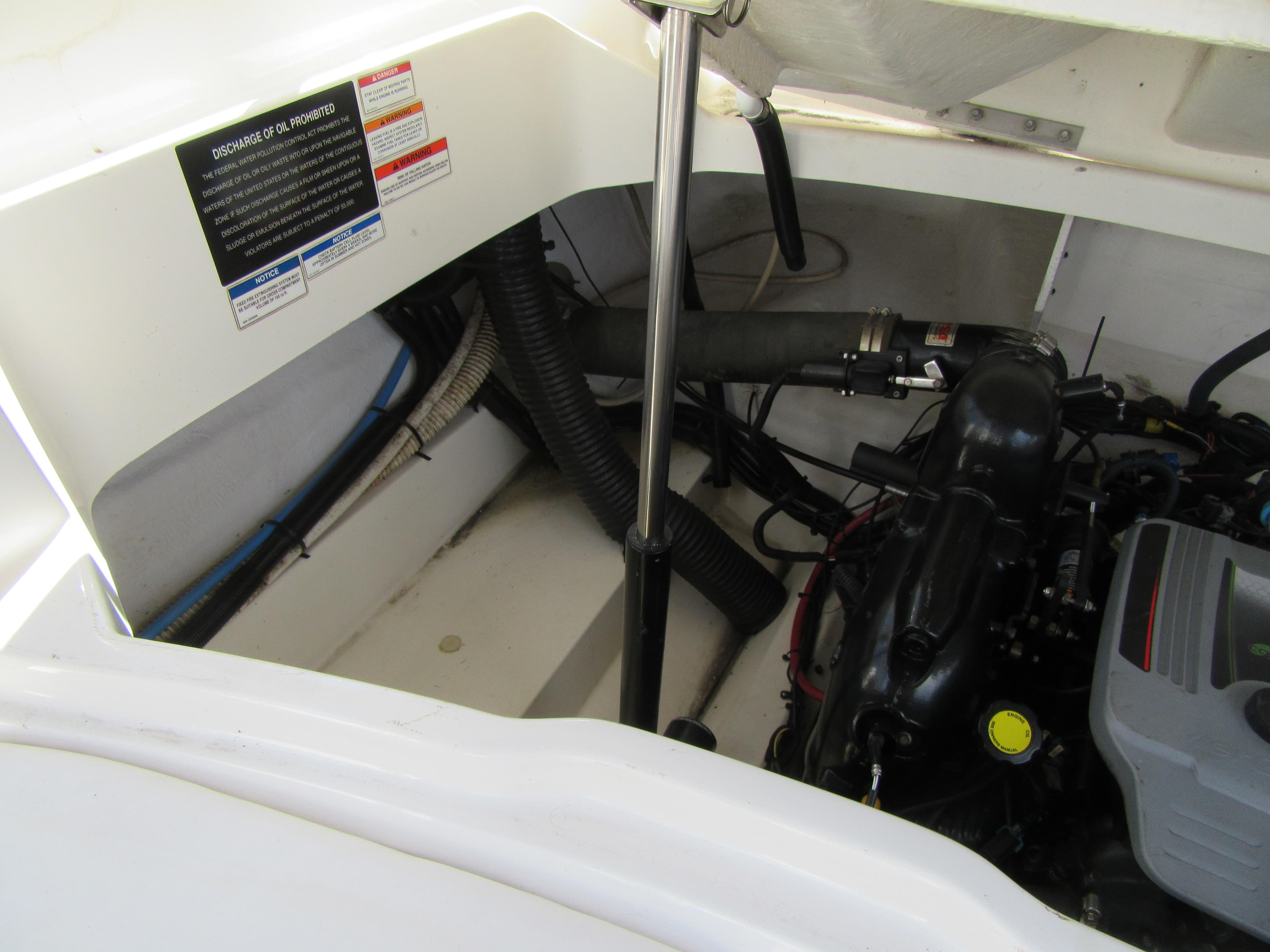 Engine compartment of a 2011 Sea Ray 250 SLX boat, showing mechanical components.