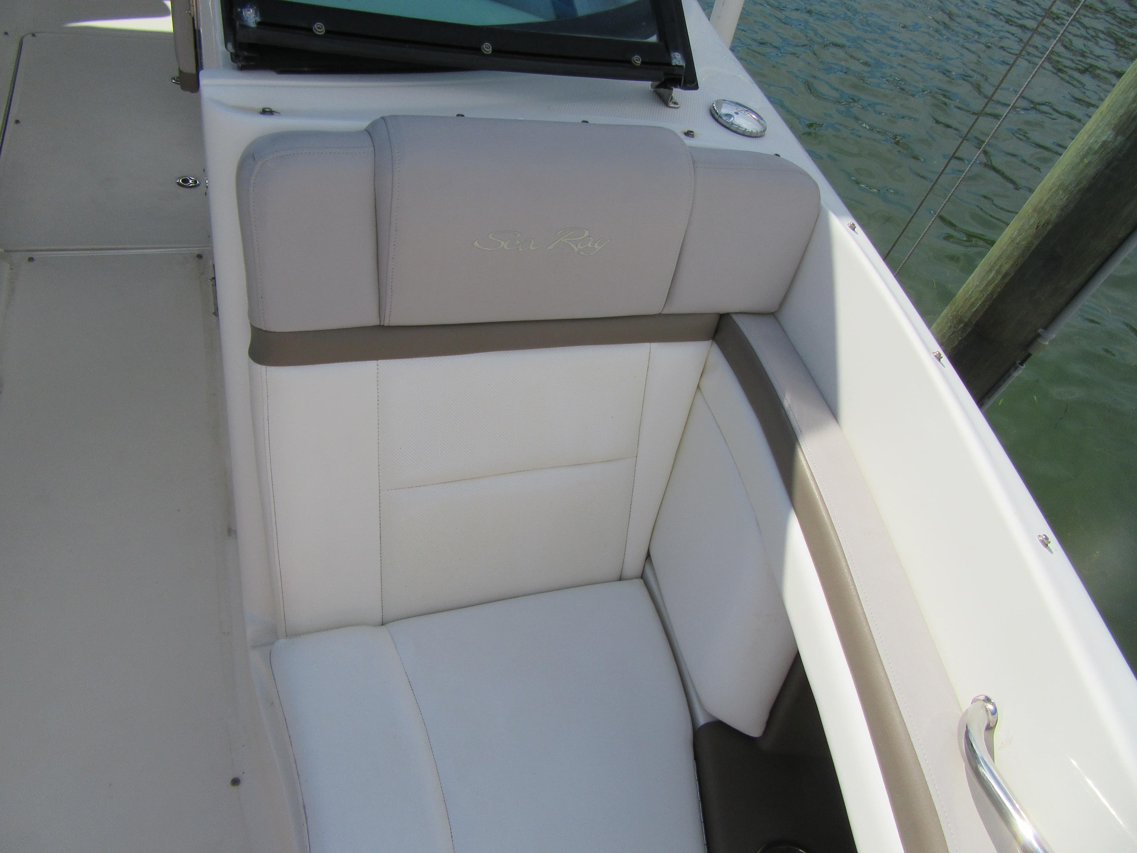 2011 Sea Ray 250 SLX boat interior with cushioned seating by the water.