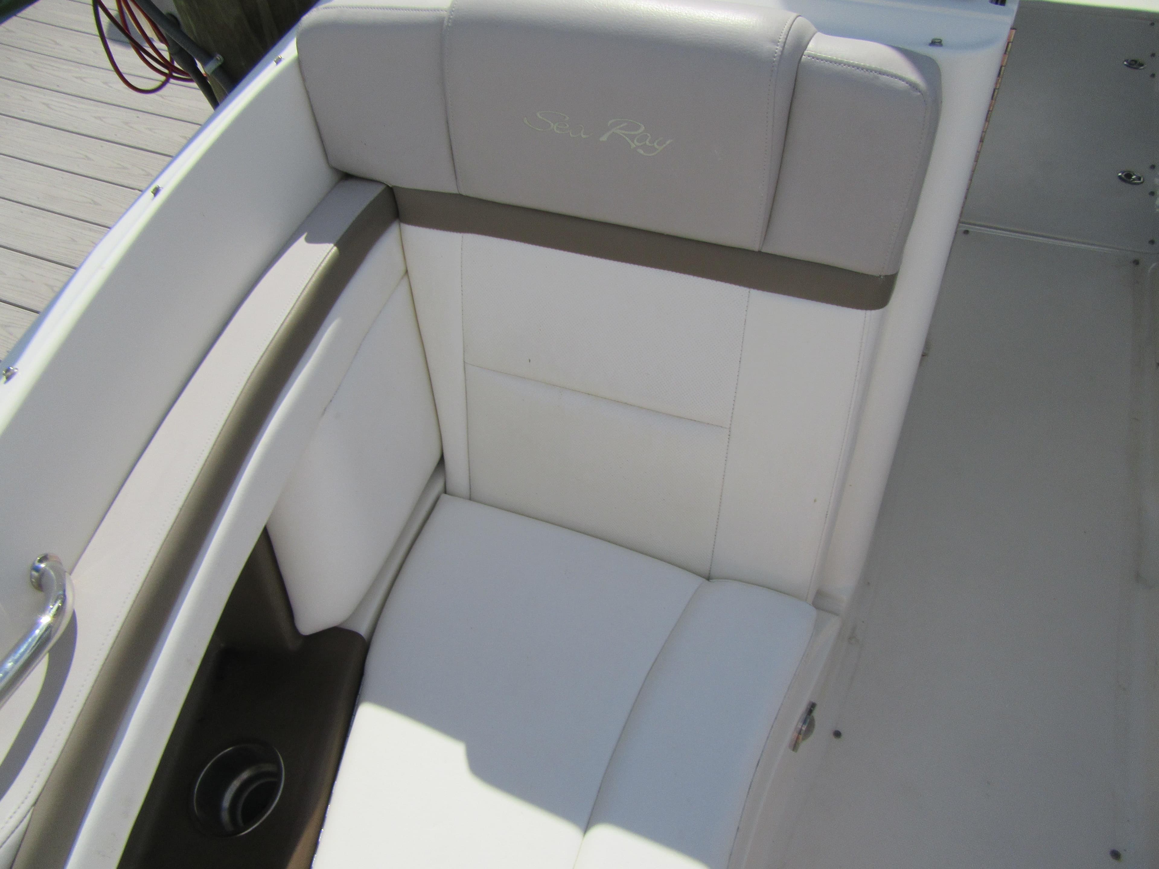 2011 Sea Ray 250 SLX boat seat with white and gray upholstery.