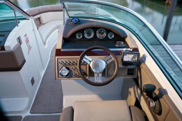 2011 Sea Ray 250 SLX boat cockpit with steering wheel and control panel.
