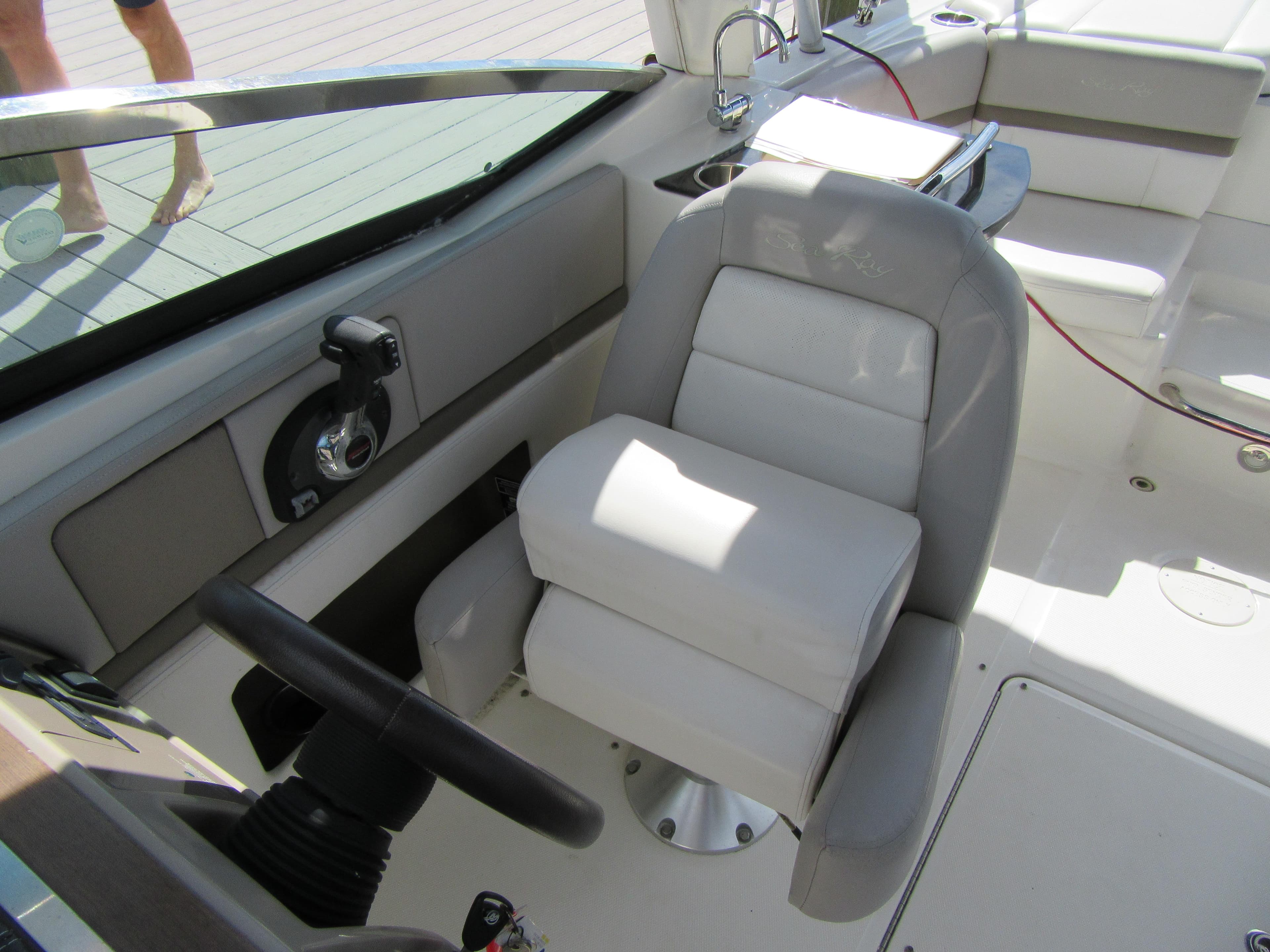 Captain's seat on a 2011 Sea Ray 250 SLX boat, featuring a sleek helm design.