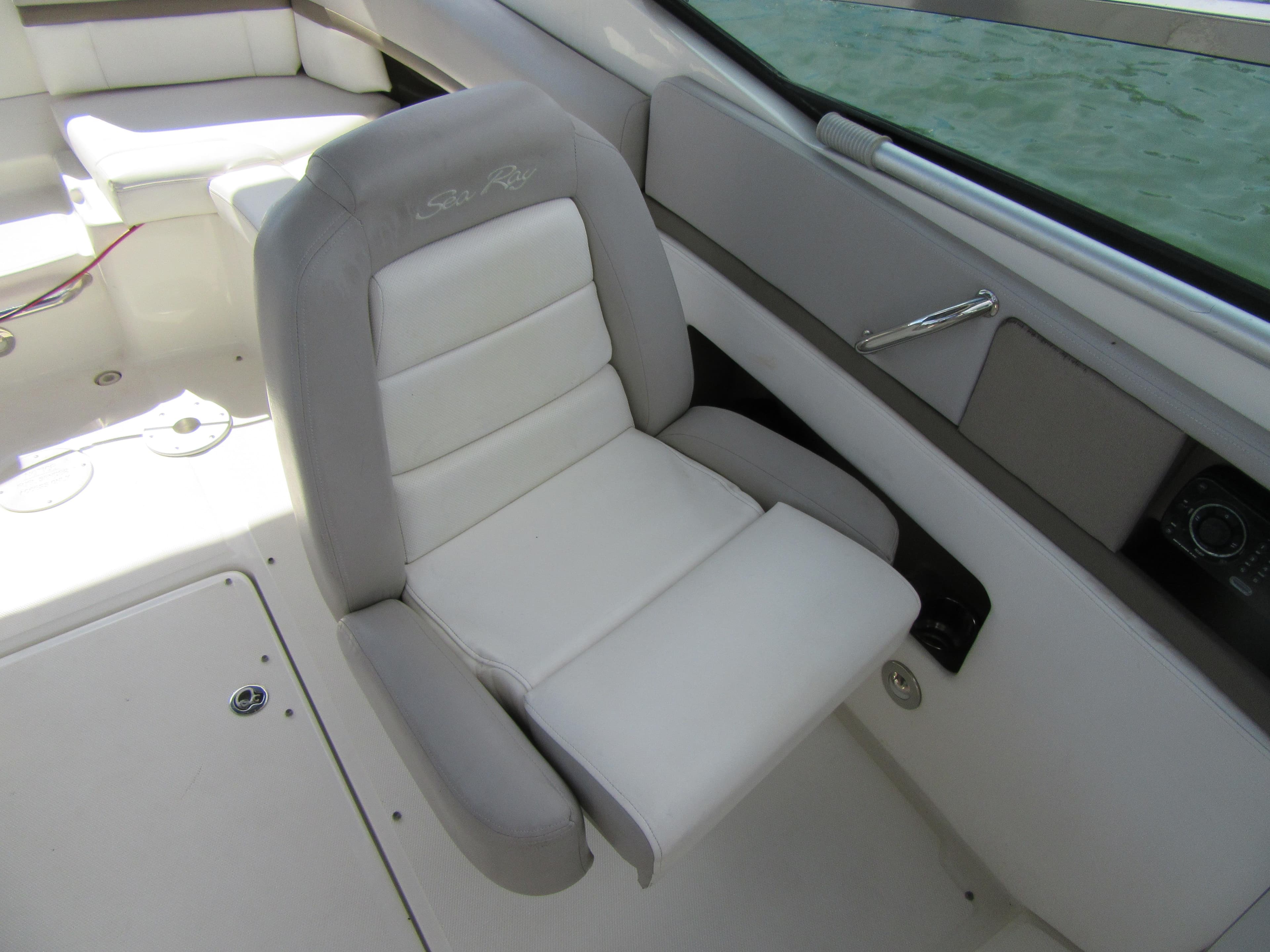 Luxurious seating on 2011 Sea Ray 250 SLX boat, featuring plush white upholstery.