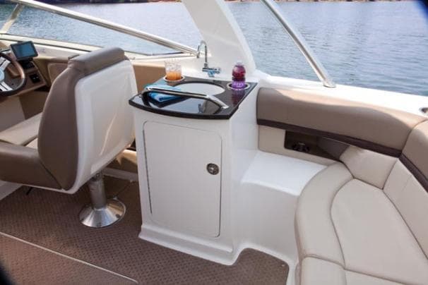 2011 Sea Ray 250 SLX boat interior with seating, table, and lake view.