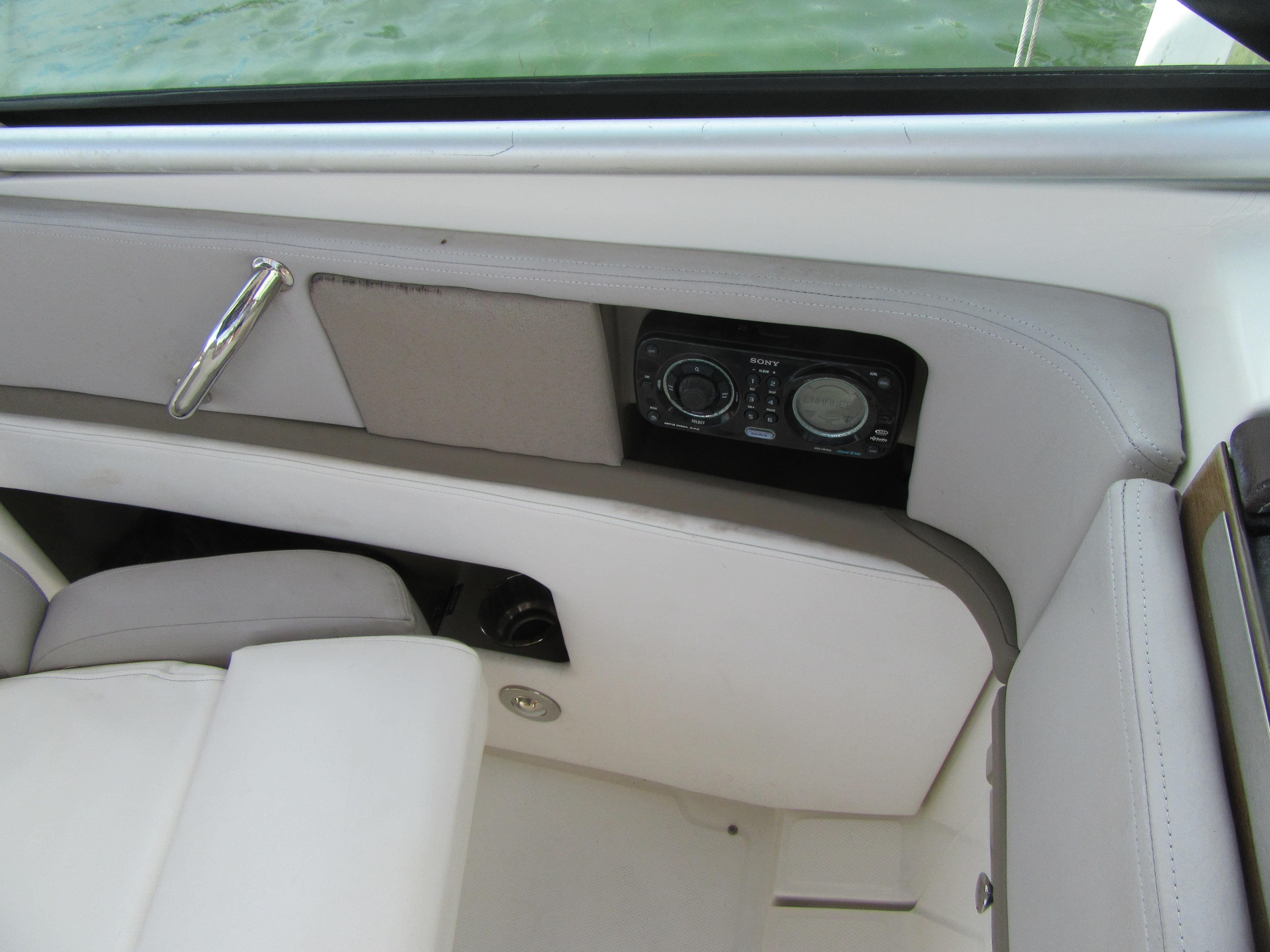 Interior of 2011 Sea Ray 250 SLX boat with audio controls and seating.