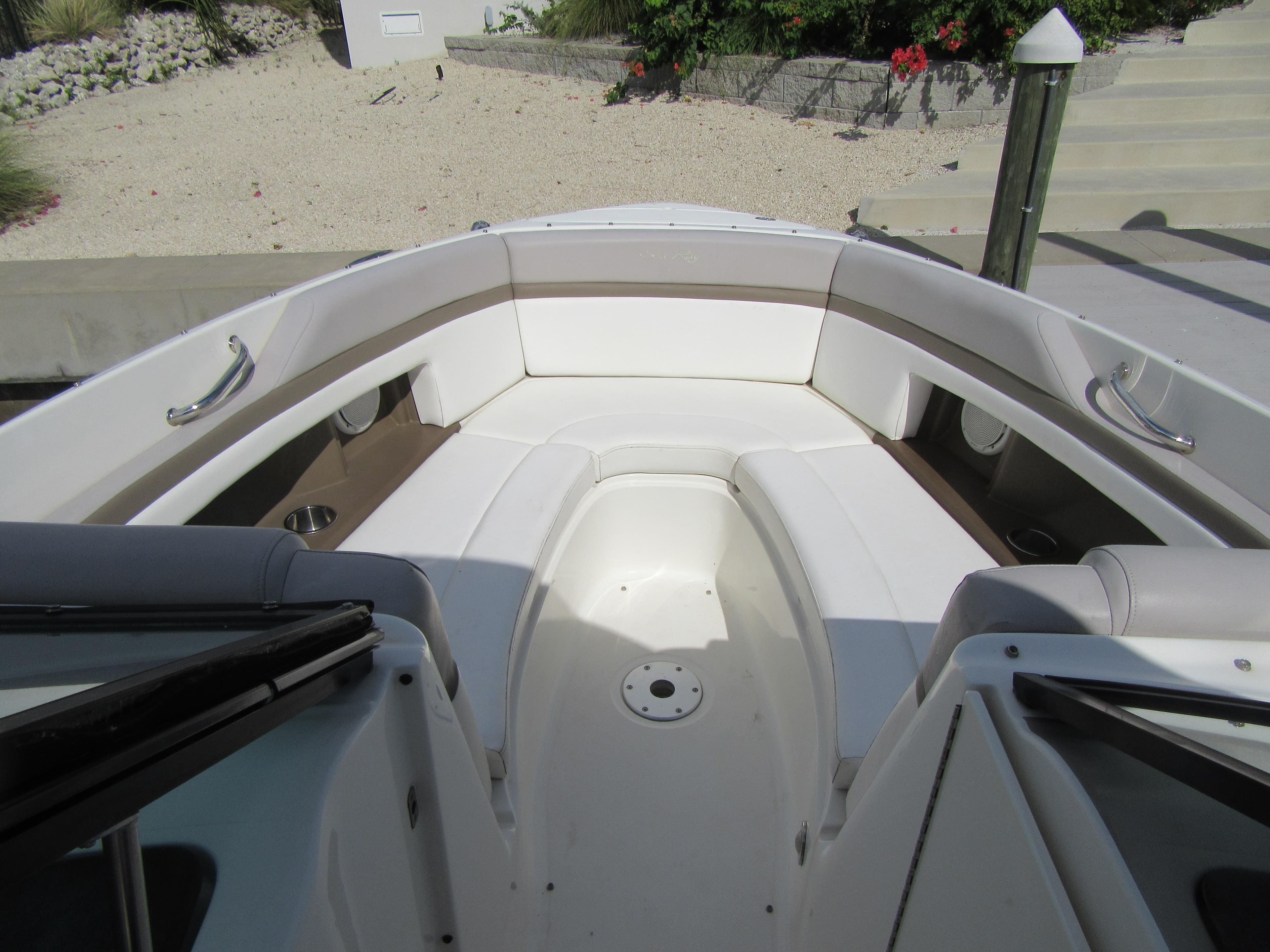 2011 Sea Ray 250 SLX boat interior with white seating and cup holders.