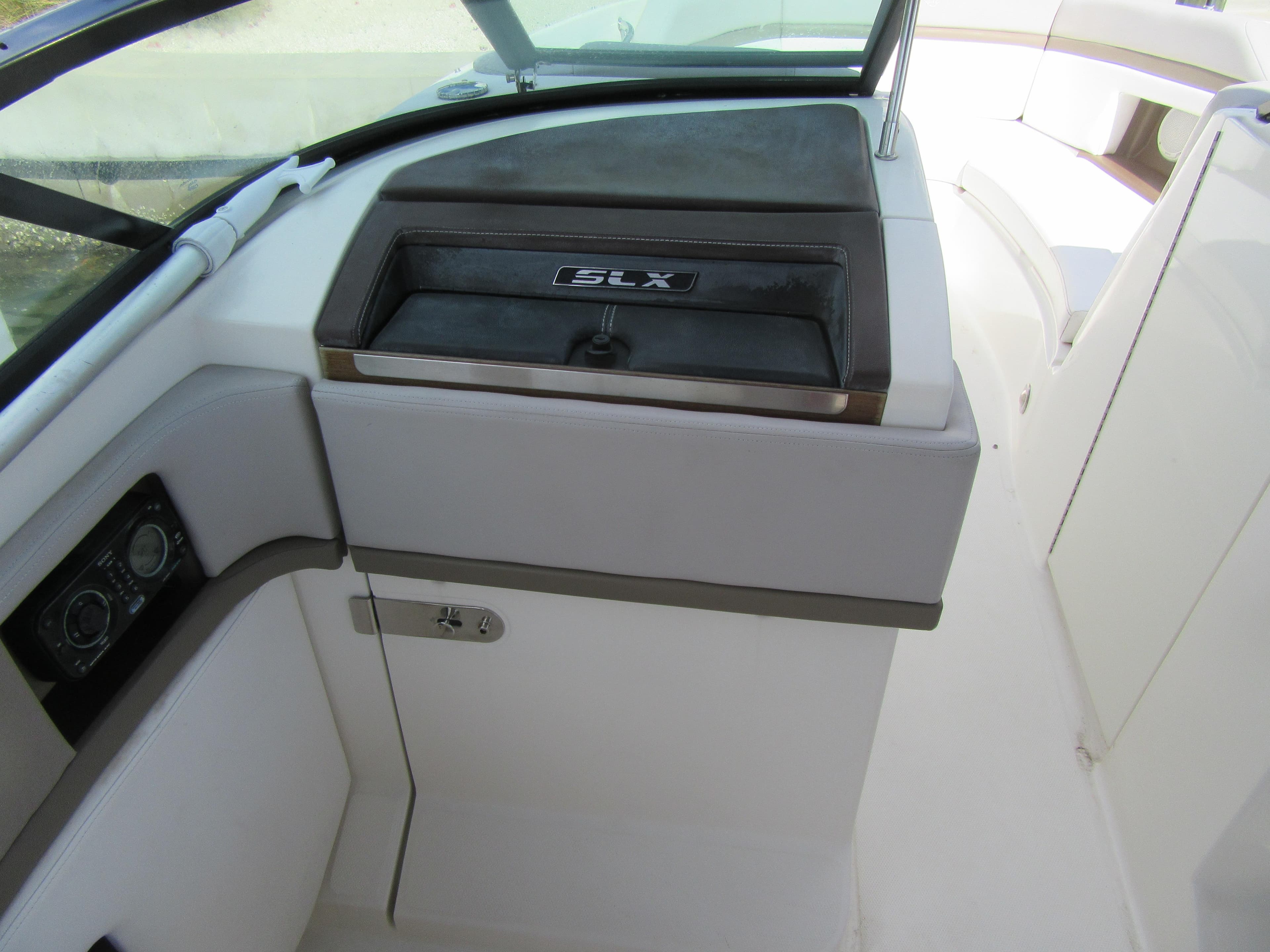 Interior of 2011 Sea Ray 250 SLX boat, featuring dashboard and seating area.