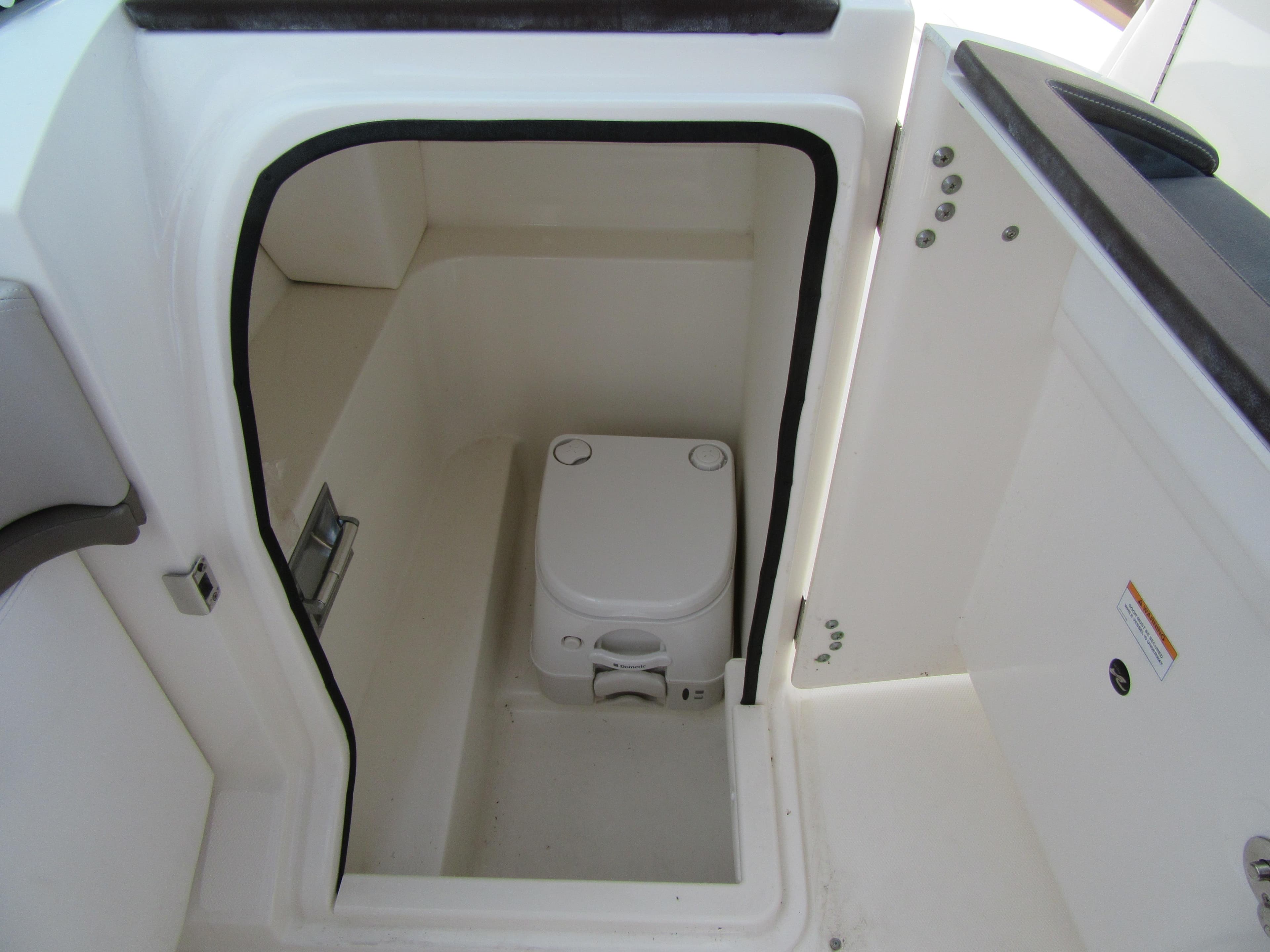 2011 Sea Ray 250 SLX boat interior with compact marine toilet.