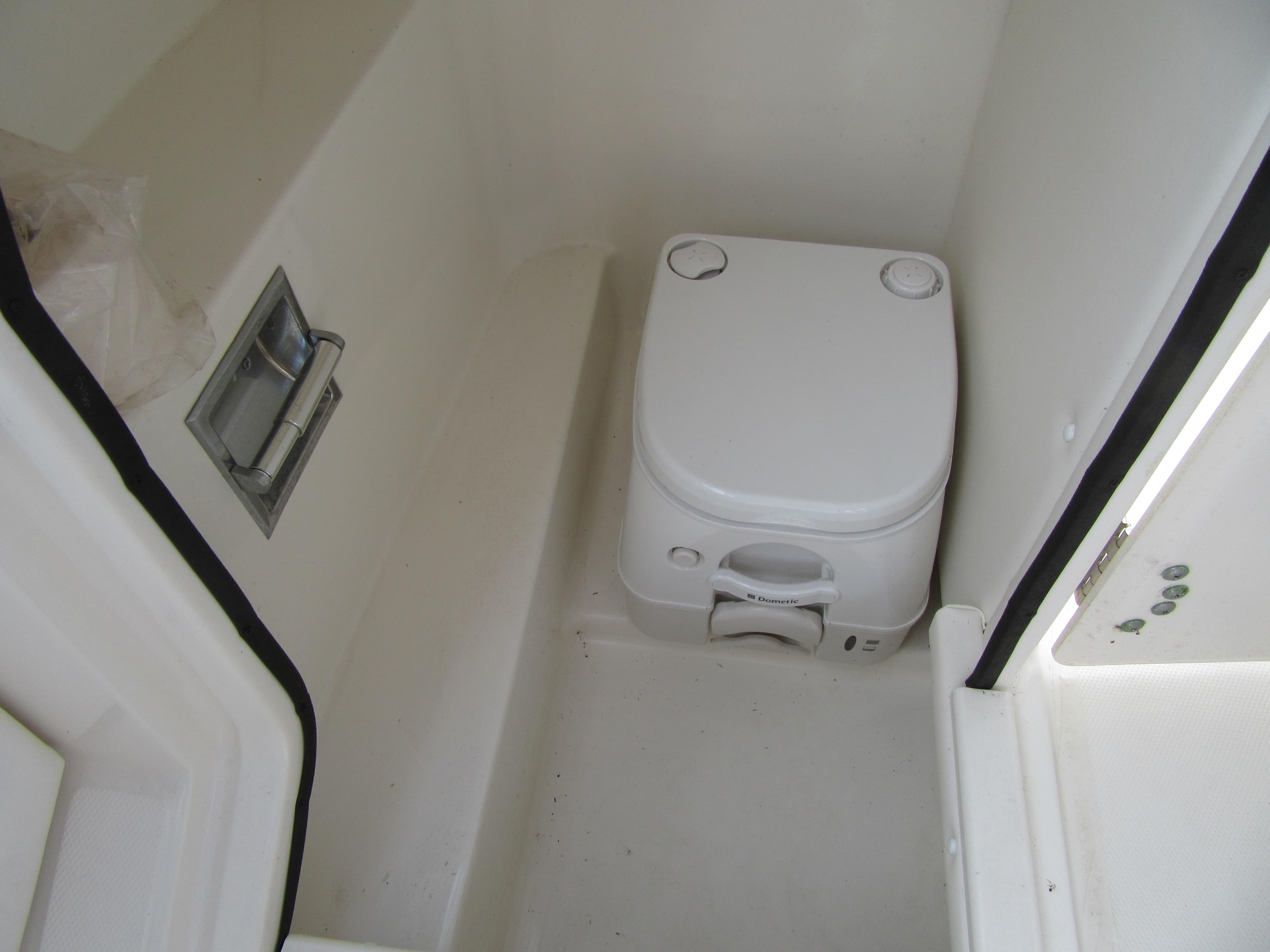 Portable toilet inside 2011 Sea Ray 250 SLX boat cabin.