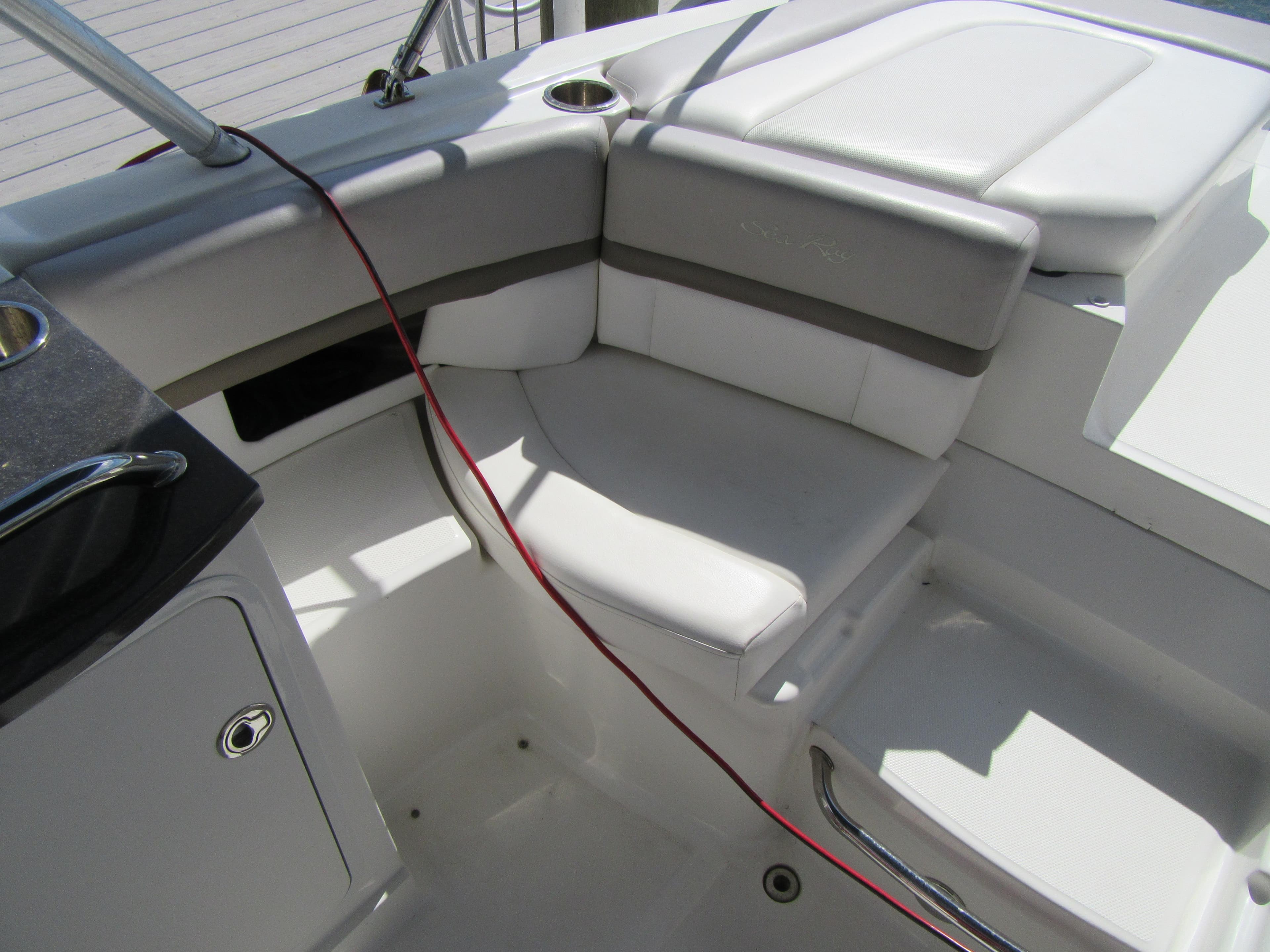 2011 Sea Ray 250 SLX boat interior with white seating and cup holder.