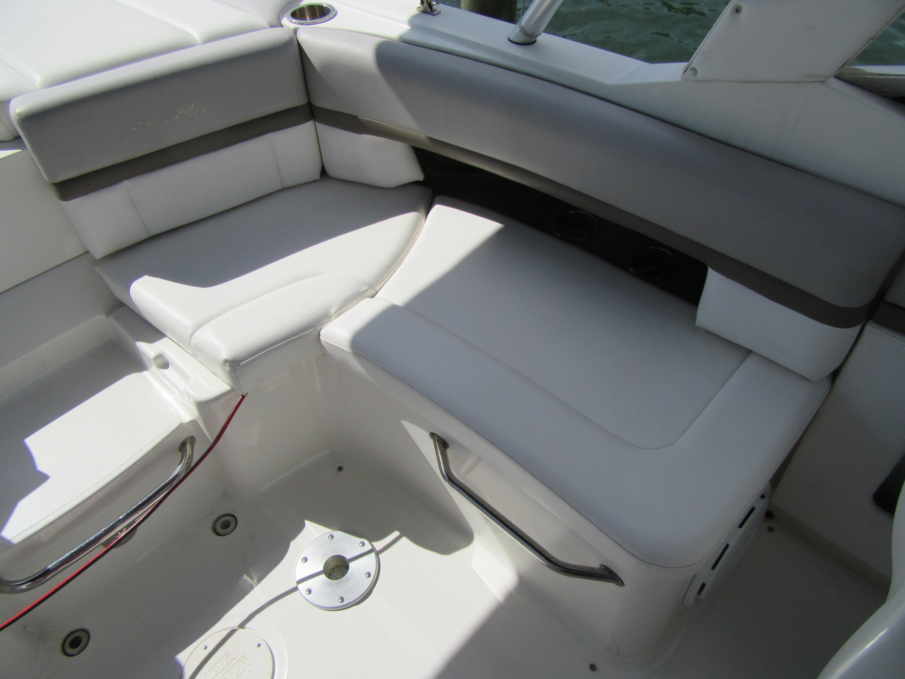 2011 Sea Ray 250 SLX boat interior with white cushioned seating.
