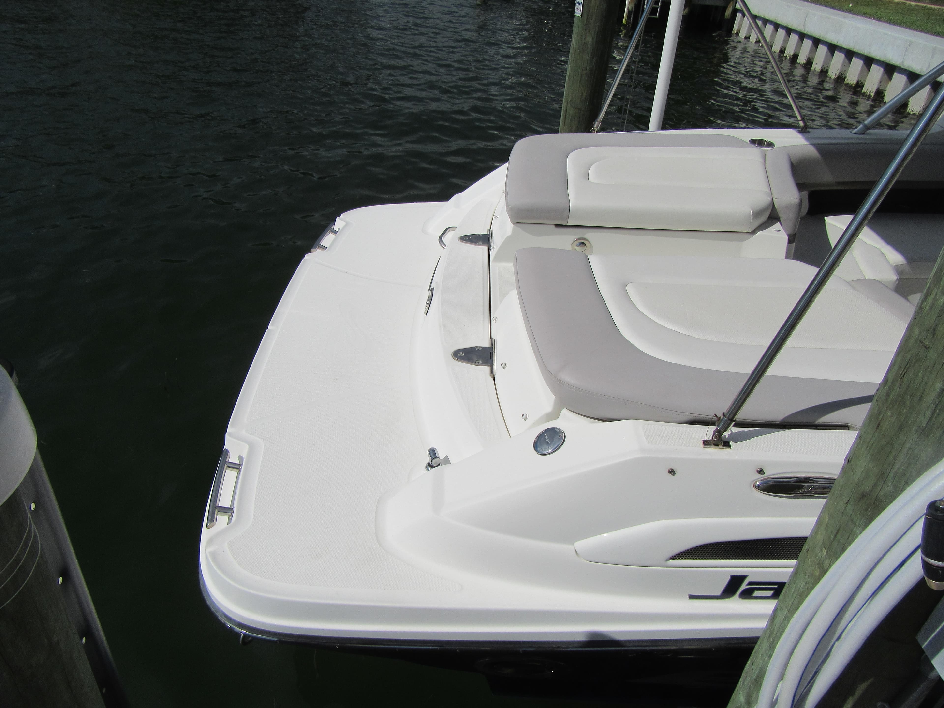 2011 Sea Ray 250 SLX boat docked, featuring a spacious rear deck and seating area.