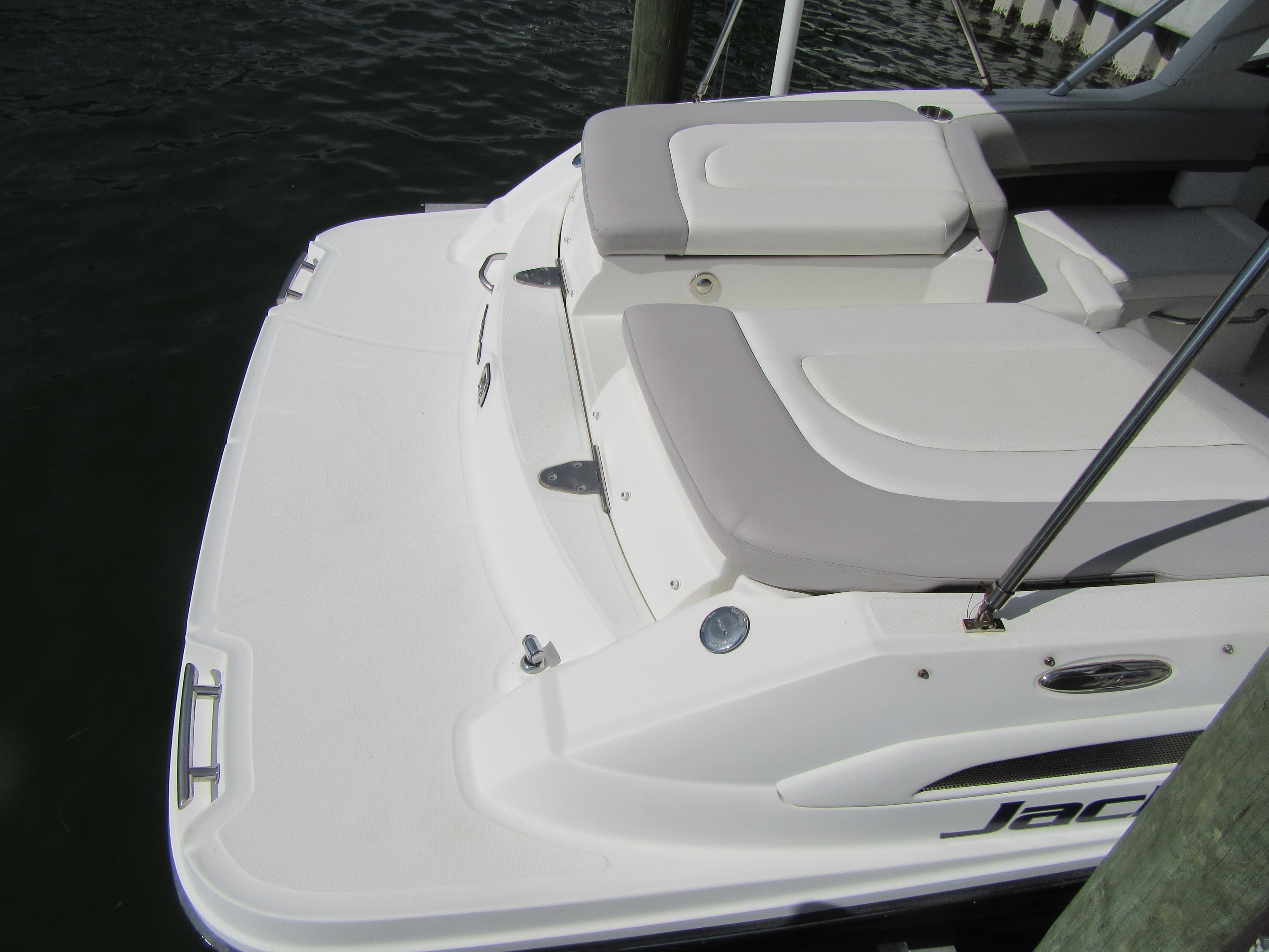 2011 Sea Ray 250 SLX boat with white seating and swim platform.
