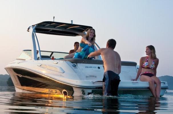 People enjoying a day on a 2011 Sea Ray 250 SLX boat in calm waters.