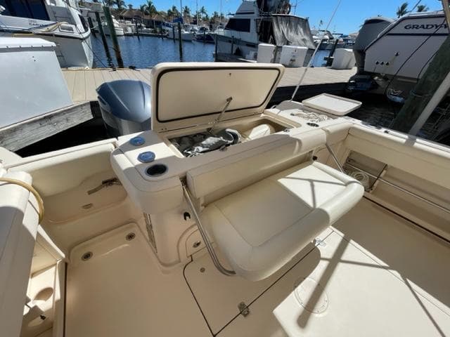 2017 Grady-White 300 Marlin boat interior at marina, featuring seating and storage compartments.