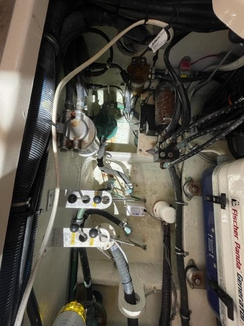 Engine compartment of a 2017 Grady-White 300 Marlin boat with visible wiring and components.