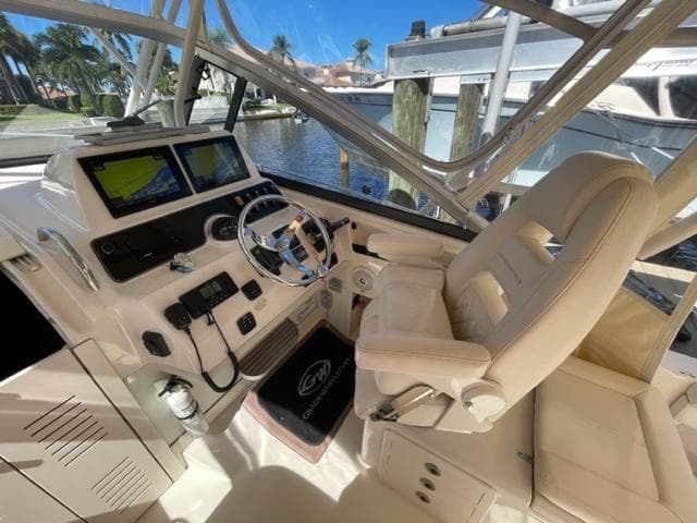 Grady-White 300 Marlin 2017 boat cockpit with steering wheel and navigation screens.