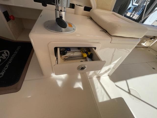 Grady-White 300 Marlin 2017 boat interior with open storage drawer and tools.