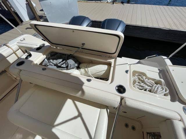 2017 Grady-White 300 Marlin boat with open storage compartments at the dock.