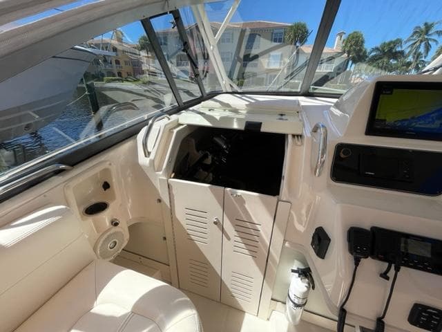 Interior of 2017 Grady-White 300 Marlin boat with helm and storage compartments.