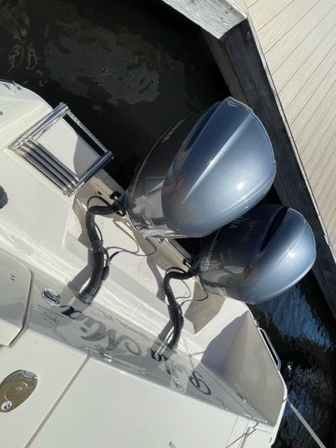 2017 Grady-White 300 Marlin boat with twin outboard engines docked.