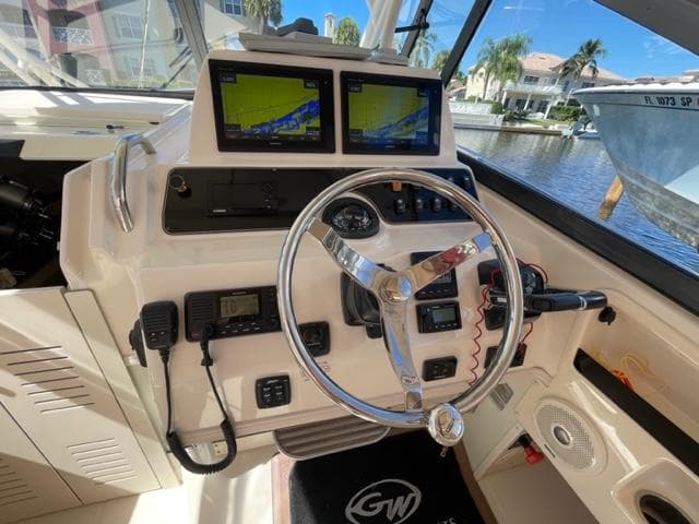 Grady-White 300 Marlin 2017 helm with dual navigation screens and steering wheel.