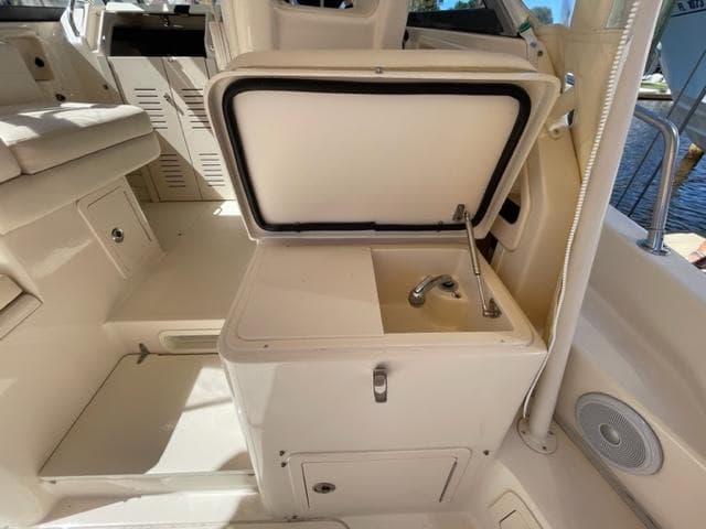 2017 Grady-White 300 Marlin boat interior with open storage compartment and sink.