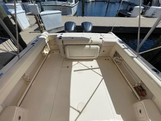 2017 Grady-White 300 Marlin boat deck with twin outboard motors at dock.