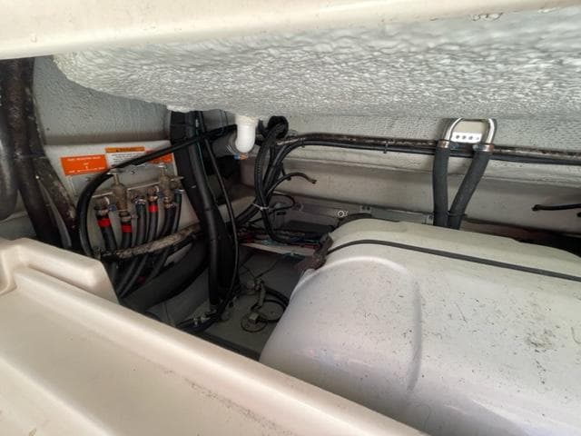 Engine compartment of a 2017 Grady-White 300 Marlin boat showing wiring and components.